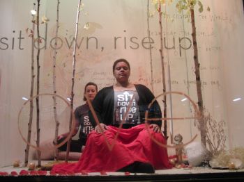 Members of the Interdependence Project are in the midst of a meditation marathon in the windows of ABC Home & Carpet (photo by twi-ny/mdr)