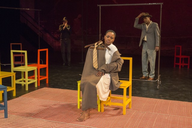 Matilda (Nonhlanhla Kheswa) clutches the object of her affection, and ultimate downfall, while Philomen (William Nadylam) sneaks up on her in THE SUIT (photo by Richard Termine)