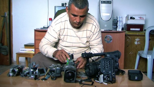 Emad Burnat displays the cameras he used to make Oscar-nominated documentary