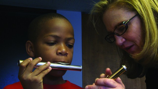 Pete Destil studies the flute with MAP mentor Gretchen Pusch in SOME KIND OF SPARK (photo by Ben Niles)