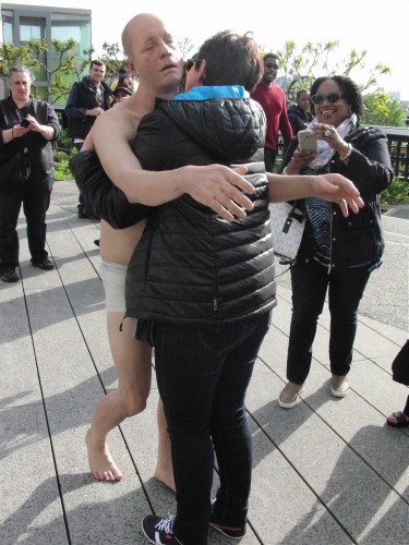 Tony Matelli’s “Sleepwalker” gets a hug from a happy stranger on the High Line (photo by twi-ny/mdr)