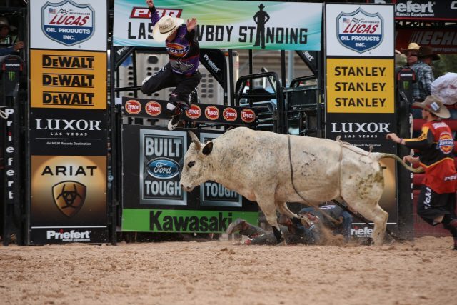 Tanner Byrne rides Mann Creek Buck N Bulls's Muddy Smile for 84.5 and Jesse Byrne is tossed during the second round of the Las Vegas Last Cowboy Standing Built Ford Tough series PBR. (Photo by Andy Watson / courtesy PBR/Bull Stock Media).