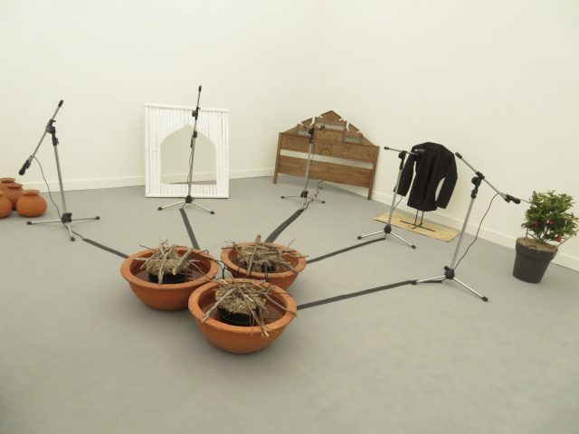  FX Harsono, Voice from the Base of the Dam, wooden panel, bamboo frame, six terracotta jugs, three terracotta pots, Maduranese textile jacket on metal stand, mat, artificial plant, five microphones withh metal stands, speakers, and sound recordings, 1994, Tyler Rollins Fine Art (photo by twi-ny/mdr)