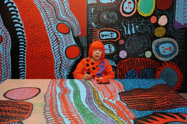 Portrait of Yayoi Kusama in her studio. Image © Yayoi Kusama. Courtesy of David Zwirner, New York; Ota Fine Arts, Tokyo/Singapore/Shanghai; Victoria Miro, London; YAYOI KUSAMA Inc.