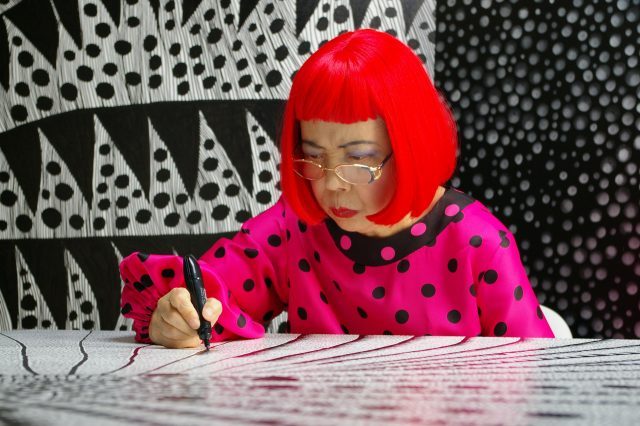 Artist Yayoi Kusama drawing in KUSAMA - INFINITY. © Tokyo Lee Productions, Inc. Courtesy of Magnolia Pictures.