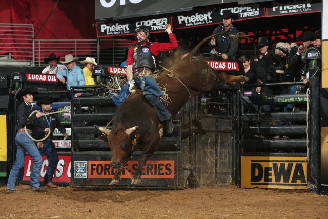 Sean Willingham attempts to ride Torres Brothers Bucking Bulls LLC's Millennium's Buck during the second round of the Duluth PBR 25th Anniversary Unleash the Beast. Photo by Andy Watson