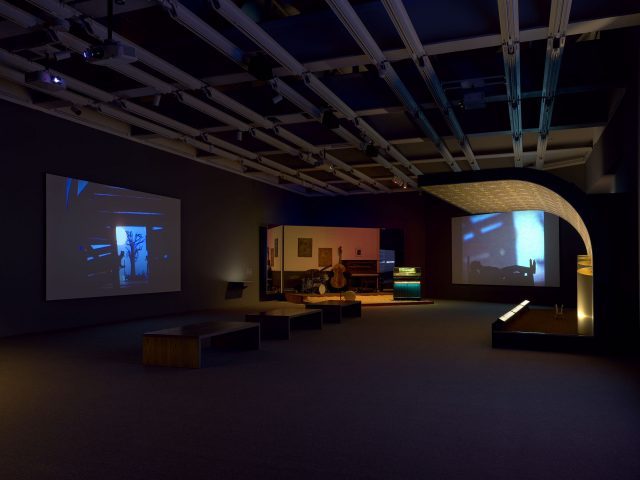 Installation view of Jason Moran (Whitney Museum of American Art, New York, September 20, 2019-January 5, 2020). Projections: Kara Walker, National Archives Microfilm M999 Roll 34: Bureau of Refugees, Freedmen and Abandoned Lands: Six Miles from Springfield on the Franklin Road, 2009. Stages from left to right: Jason Moran, STAGED: Slugs’ Saloon, 2018; Jason Moran, STAGED: Savoy Ballroom 1, 2015. Photograph by Ron Amstutz